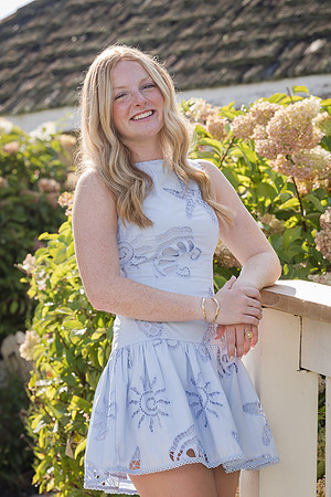 laughing in front of blooming hydrangeas for this senior portrait session this august at lake chatuge